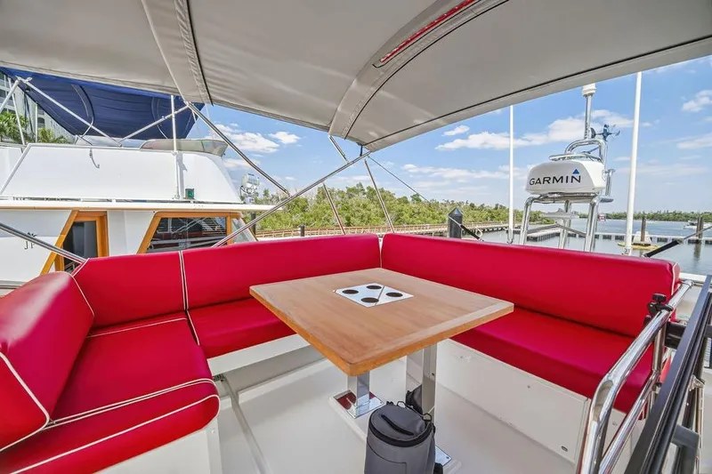Slide: The Image of Luxurious 2024 Prestige 520 yacht with red seating and wooden table on deck. - 10