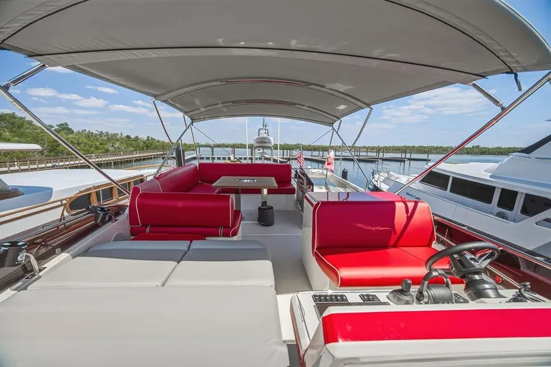 Slide: The Image of Luxurious 2024 Prestige 520 yacht with red seating and spacious deck under canopy. - 13