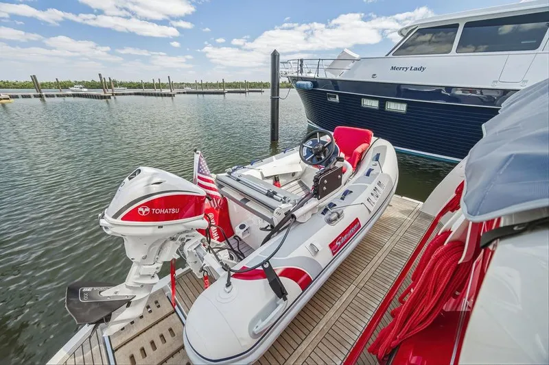 Slide: The Image of Luxury yacht Prestige 520, 2024 model, docked with inflatable boat and Tohatsu motor. - 16