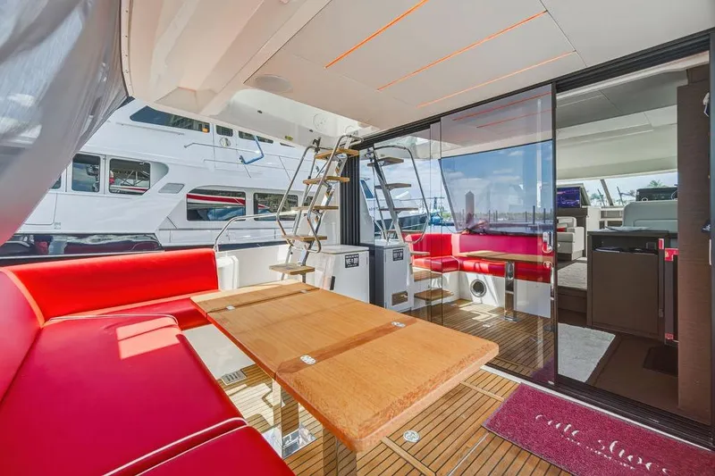 Slide: The Image of Luxurious 2024 Prestige 520 yacht interior with red seating, wooden table, and modern design. - 20