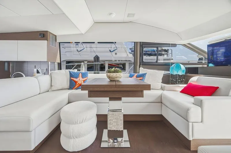 Slide: The Image of Luxurious interior of 2024 Prestige 520 yacht with modern white seating and decorative pillows. - 26