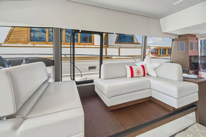 Slide: The Image of Luxurious interior of 2024 Prestige 520 yacht with white seating and decorative pillows. - 28
