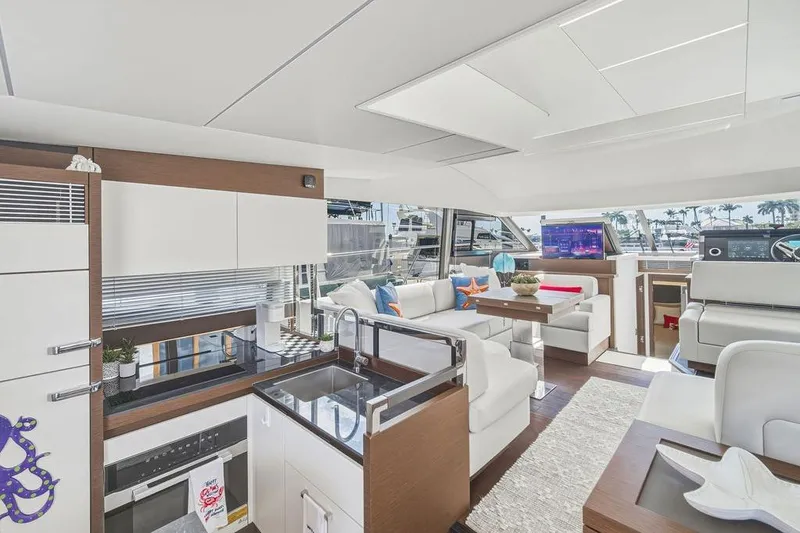 Slide: The Image of Luxurious interior of 2024 Prestige 520 yacht with modern kitchen and spacious seating area. - 30