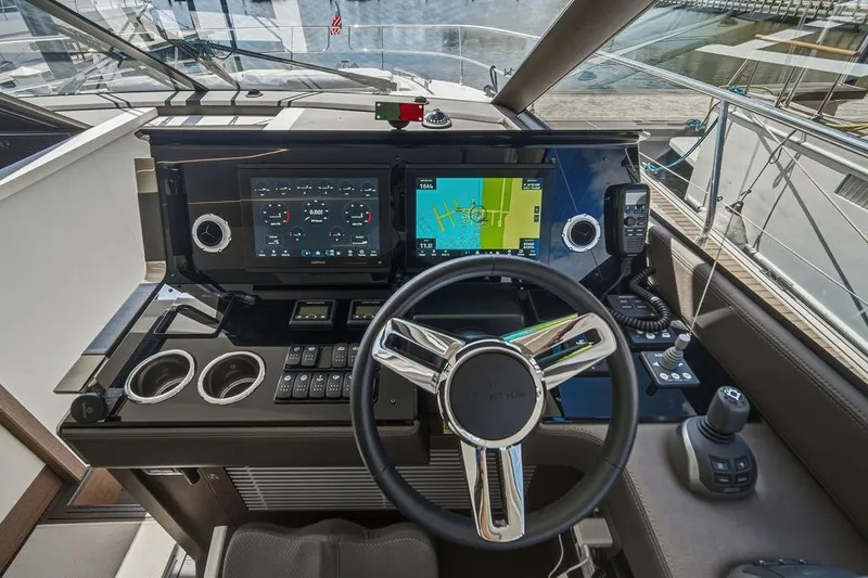 Slide: The Image of Cockpit of 2024 Prestige 520 yacht with advanced navigation systems and sleek steering wheel. - 31
