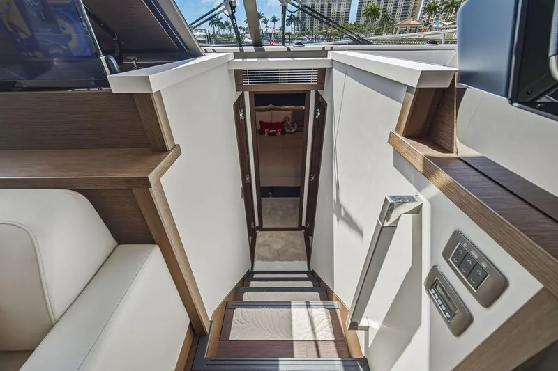 Slide: The Image of Interior view of 2024 Prestige 520 yacht, featuring modern staircase and luxurious cabin entrance. - 33