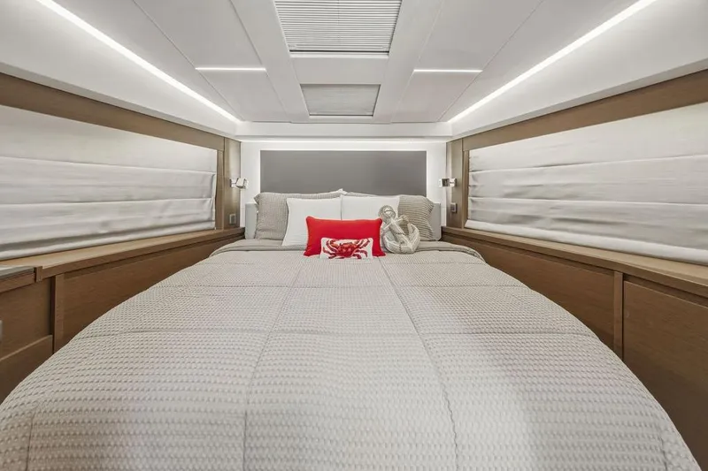 Slide: The Image of Luxurious bedroom interior of 2024 Prestige 520 yacht with modern design and cozy bedding. - 34