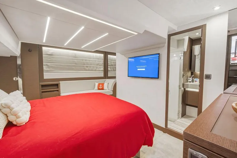 Slide: The Image of Luxurious 2024 Prestige 520 yacht bedroom with red bedding, modern lighting, and ensuite bathroom. - 36