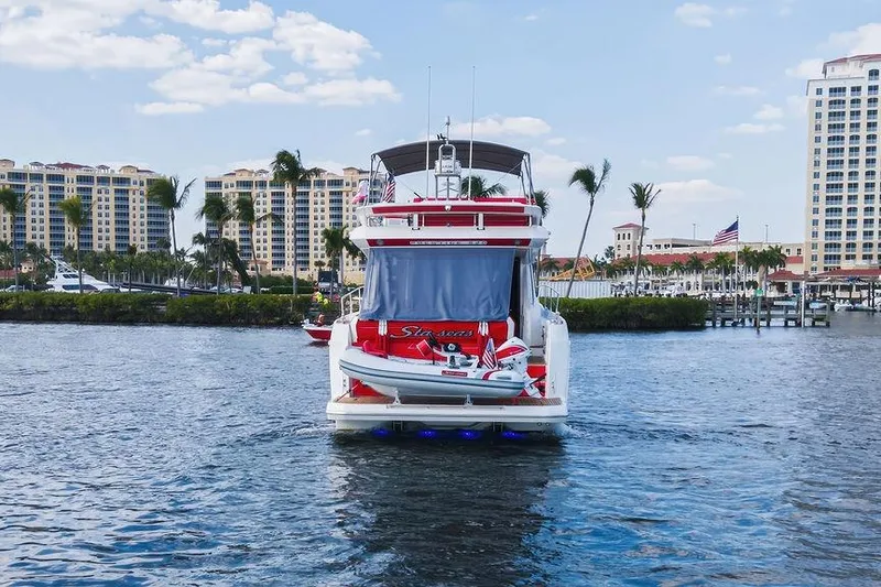 Slide: The Image of Luxury 2024 Prestige 520 yacht docked in scenic marina with palm trees and buildings. - 4