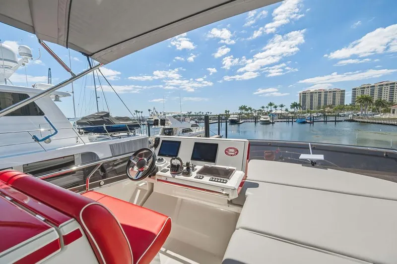 Slide: The Image of Luxurious 2024 Prestige 520 yacht interior with marina view, featuring modern navigation equipment. - 9