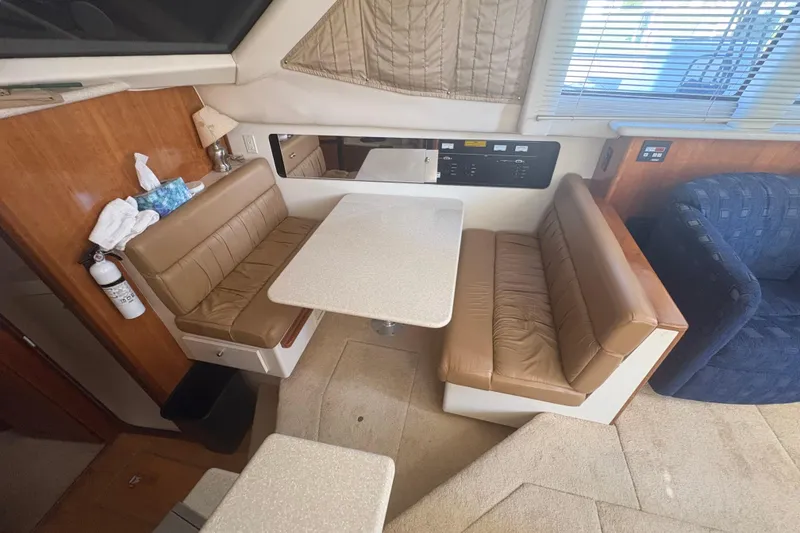 Slide: The Image of Interior of 2002 Carver 356 Aft Cabin Motor Yacht with dining area and leather seating. - 11