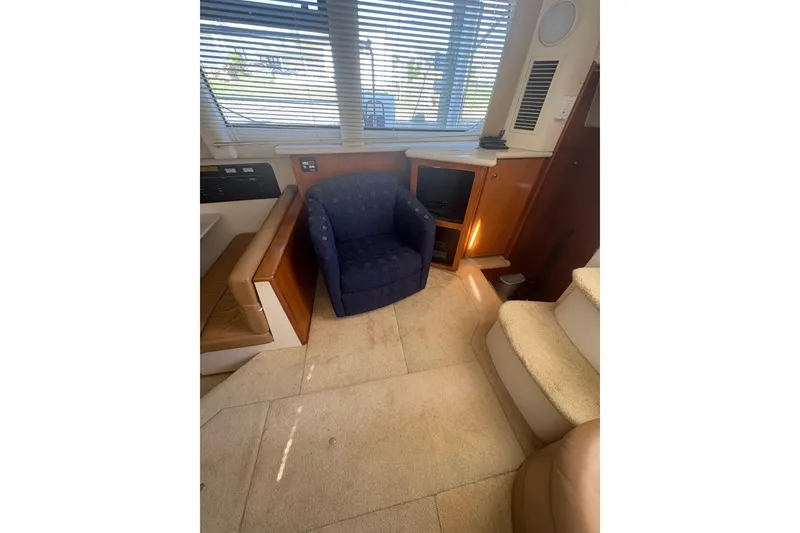 Slide: The Image of Interior of 2002 Carver 356 Aft Cabin Motor Yacht with blue chair and carpeted stairs. - 14