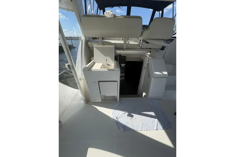 Slide: The Image of 2002 Carver 356 Aft Cabin Motor Yacht interior with seating and kitchenette. - 16