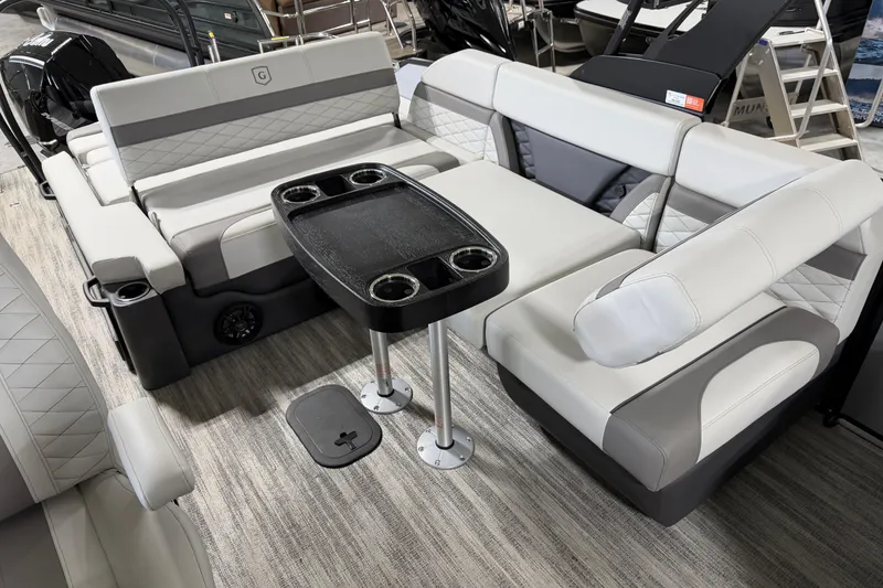 Slide: The Image of Luxurious seating area on 2026 Godfrey Monaco 235 SFL pontoon boat with table and cup holders. - 7