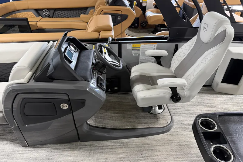 Slide: The Image of Captain's chair and helm of 2026 Godfrey Monaco 235 SFL pontoon boat, featuring modern design. - 8
