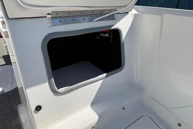 Slide: The Image of Storage compartment in a 2018 Tahoe 500 TF boat, featuring a sleek white interior. - 13