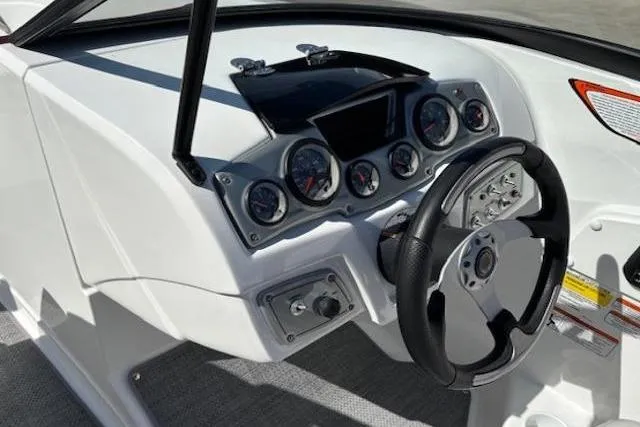 Slide: The Image of 2018 Tahoe 500 TF boat dashboard with steering wheel and gauges. - 18