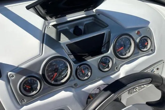 Slide: The Image of Dashboard of a 2018 Tahoe 500 TF boat with multiple gauges and steering wheel. - 19