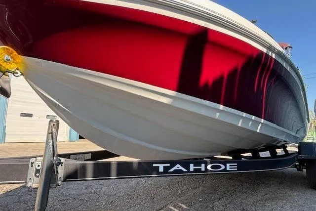 Slide: The Image of 2018 Tahoe 500 TF boat on trailer, featuring a sleek red and white hull design. - 2