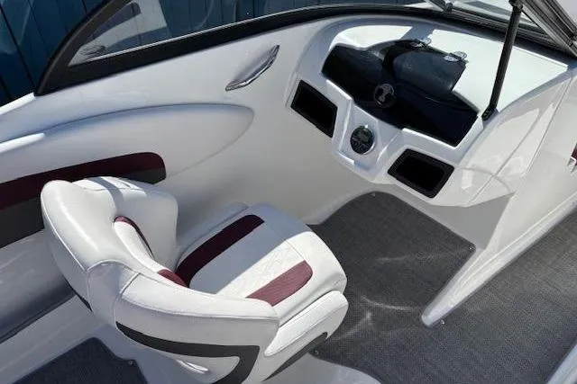 Slide: The Image of 2018 Tahoe 500 TF boat interior with white and maroon seating, sleek dashboard design. - 20