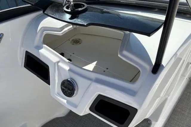 Slide: The Image of 2018 Tahoe 500 TF boat dashboard with storage compartment and cup holder. - 22