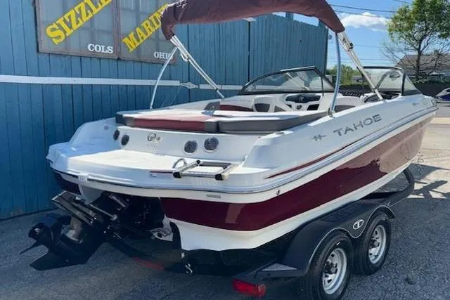 Slide: The Image of 2018 Tahoe 500 TF boat on trailer, parked near blue building. - 3