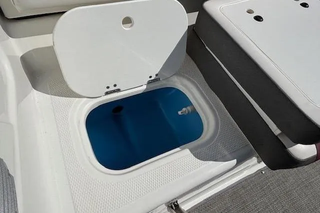 Slide: The Image of Open storage compartment on a 2018 Tahoe 500 TF boat, featuring a blue interior. - 31