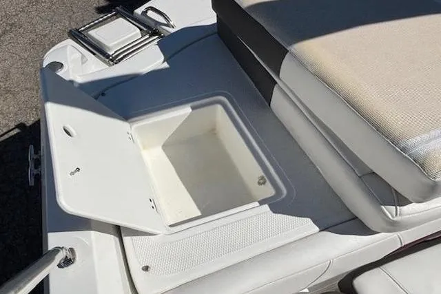 Slide: The Image of Open storage compartment on a 2018 Tahoe 500 TF boat, featuring cushioned seating. - 32