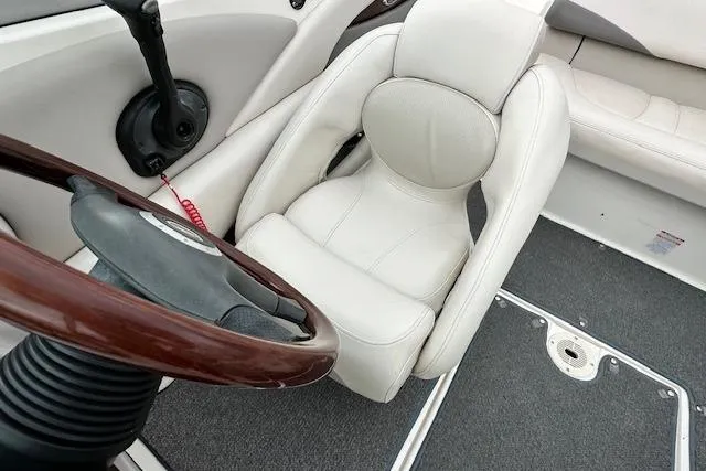 Slide: The Image of 2007 Chaparral 204 SSi boat interior with white captain's seat and steering wheel. - 10