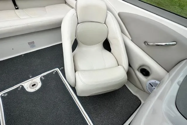 Slide: The Image of 2007 Chaparral 204 SSi boat interior with white seating and carpeted flooring. - 11