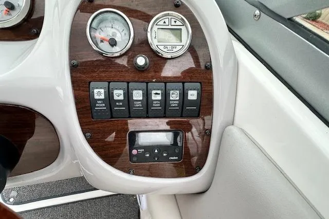 Slide: The Image of Dashboard controls of a 2007 Chaparral 204 SSi boat with gauges and switches. - 13