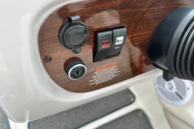 Slide: The Image of Dashboard controls of a 2007 Chaparral 204 SSi boat with wood paneling. - 16