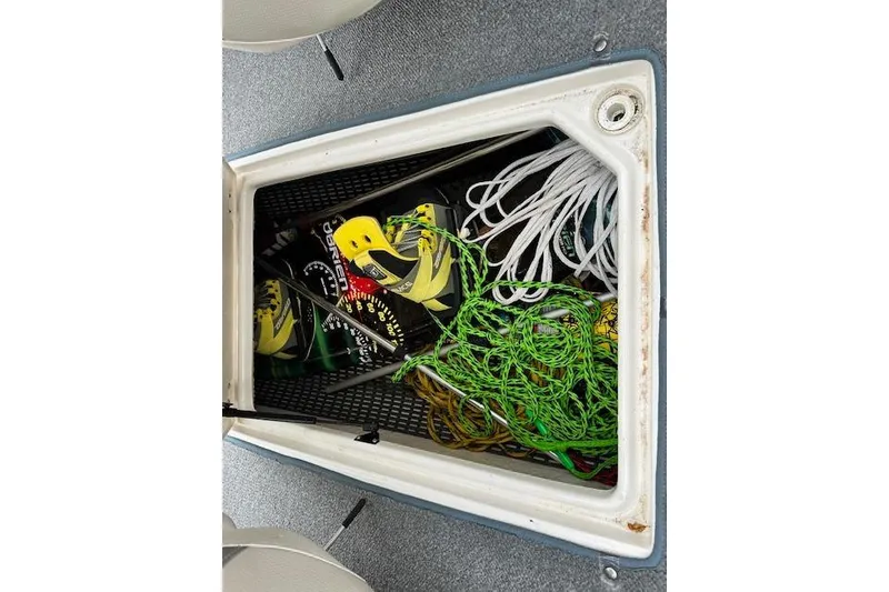 Slide: The Image of Storage compartment of a 2007 Chaparral 204 SSi boat with ropes and gear. - 18