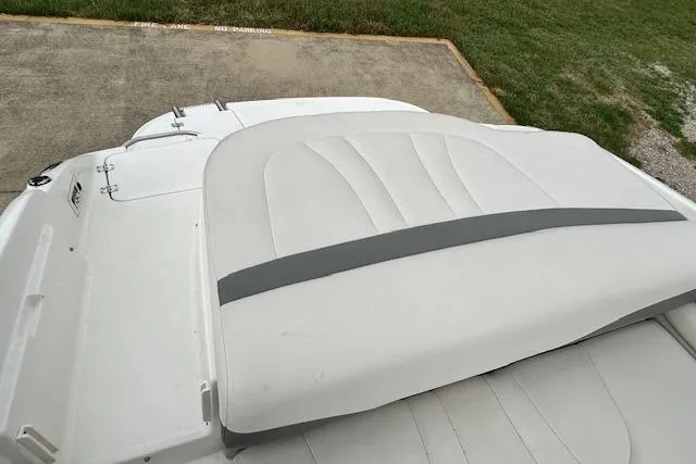 Slide: The Image of 2007 Chaparral 204 SSi boat with white and gray seating, parked on concrete. - 8