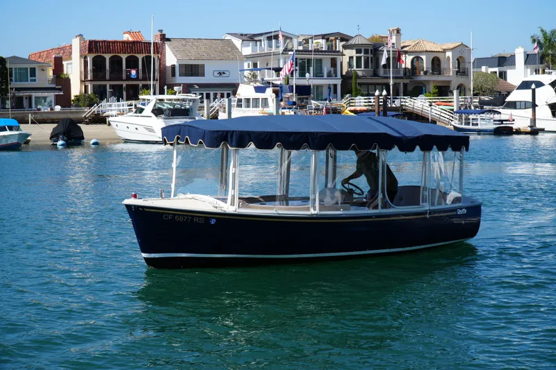 Slide: The Image of 2008 Duffy Snug Harbor 18 boat cruising in a scenic waterfront area. - 3