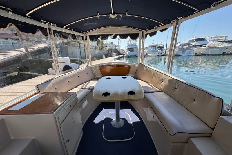 Slide: The Image of Interior of 2008 Duffy Snug Harbor 18 boat with seating and table, docked at marina. - 4