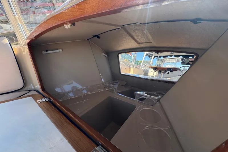 Slide: The Image of Interior view of 2008 Duffy Snug Harbor 18 boat cabin with window and seating area. - 8