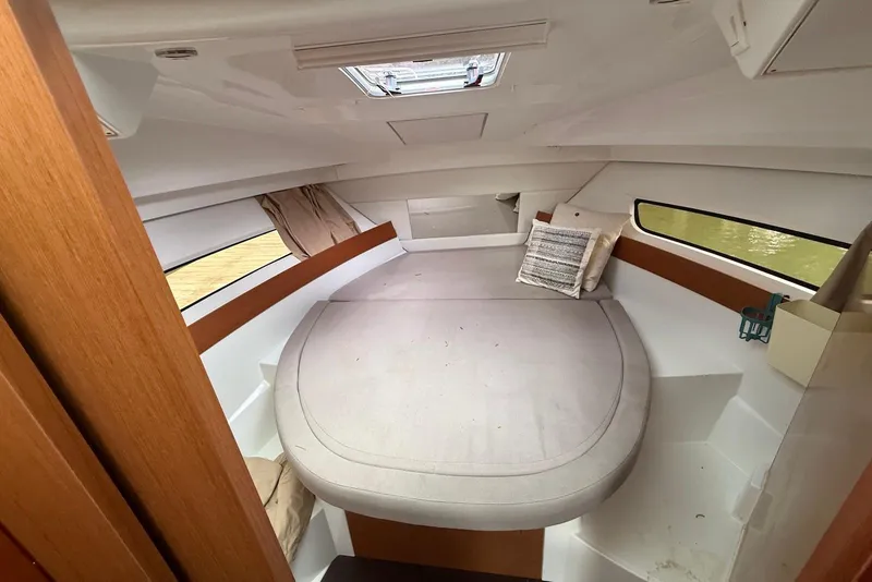 Slide: The Image of 2017 Jeanneau NC 895 cabin interior with cozy bed and natural light. - 10