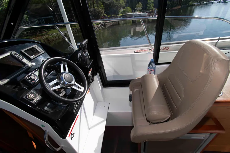 Slide: The Image of Interior helm of 2017 Jeanneau NC 895 boat with steering wheel and captain's chair. - 14
