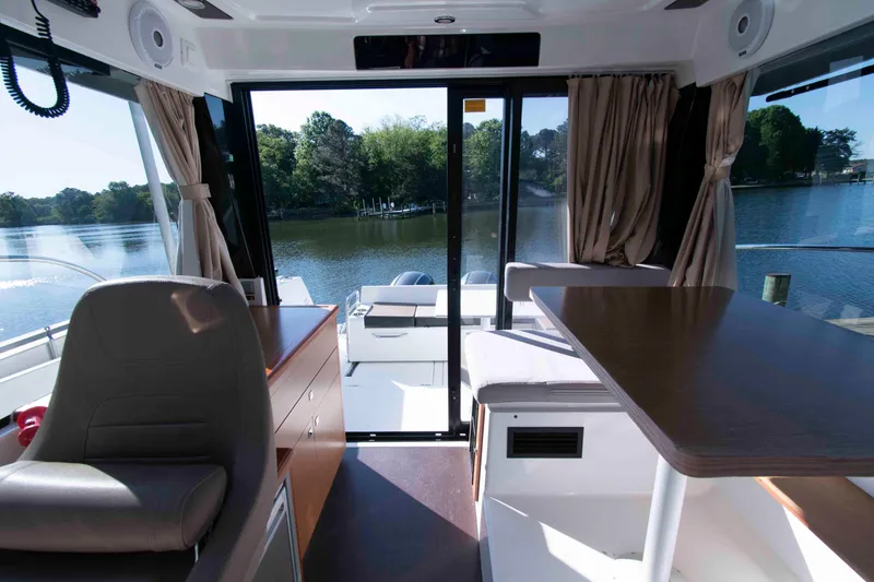 Slide: The Image of Interior view of 2017 Jeanneau NC 895 boat with seating and water view. - 18
