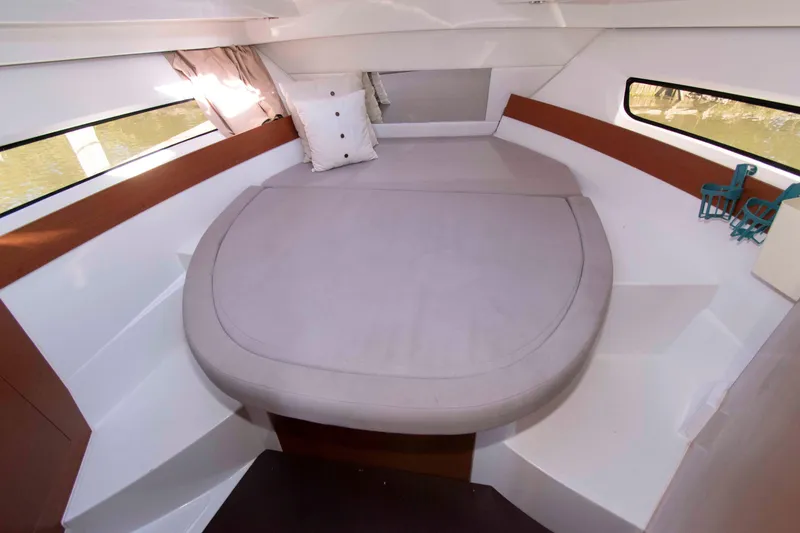 Slide: The Image of Interior cabin of 2017 Jeanneau NC 895 with a cozy bed and windows. - 19