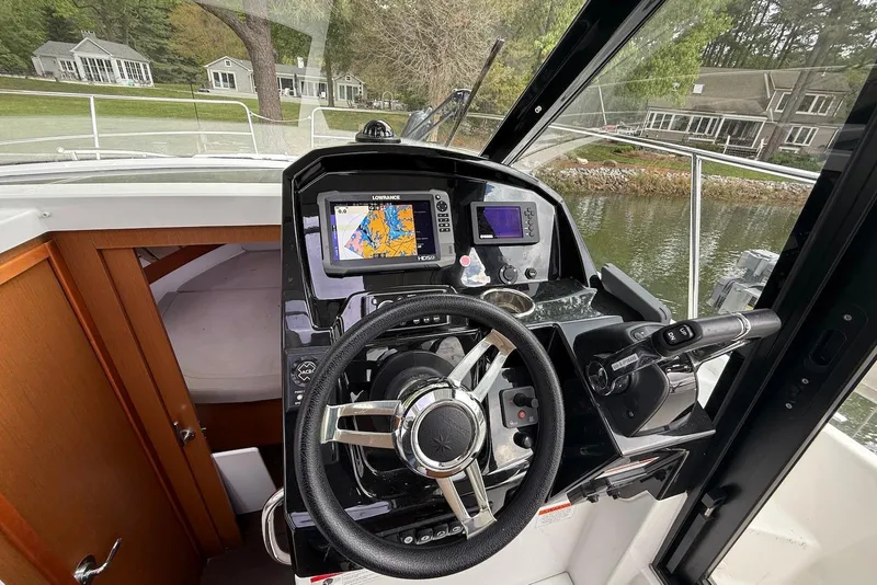 Slide: The Image of Cockpit of 2017 Jeanneau NC 895 boat with navigation system and steering wheel. - 9