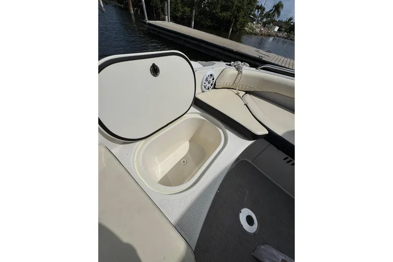 Slide: The Image of 2022 Stingray 192 SC boat interior with open storage compartment and seating area. - 19