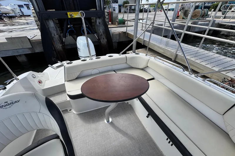 Slide: The Image of 2022 Stingray 192 SC boat interior with seating and table at dock. - 7