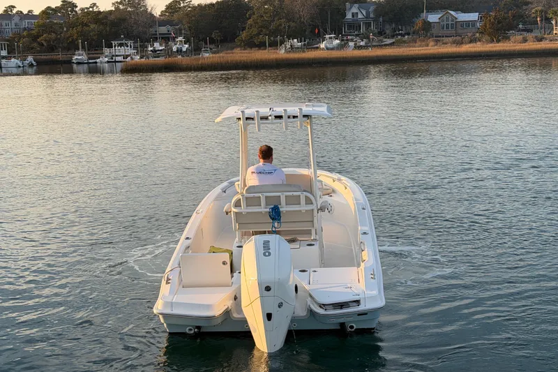 Slide: The Image of 2023 Boston Whaler 220 Dauntless boat cruising on a calm waterway. - 28