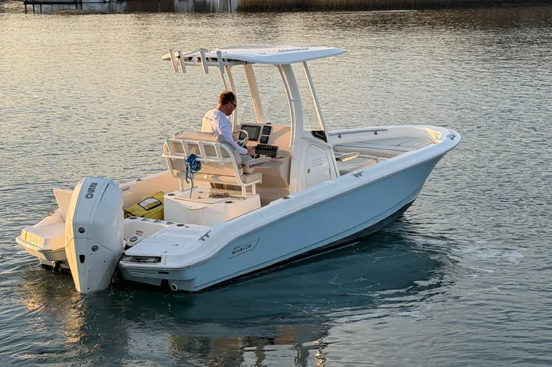 Slide: The Image of 2023 Boston Whaler 220 Dauntless boat cruising on calm water at sunset. - 31