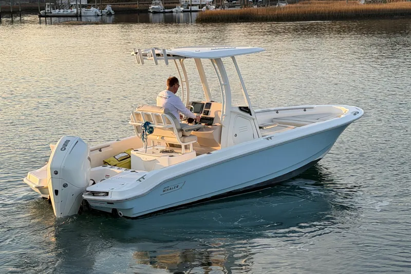 Slide: The Image of 2023 Boston Whaler 220 Dauntless boat cruising on calm waters. - 32