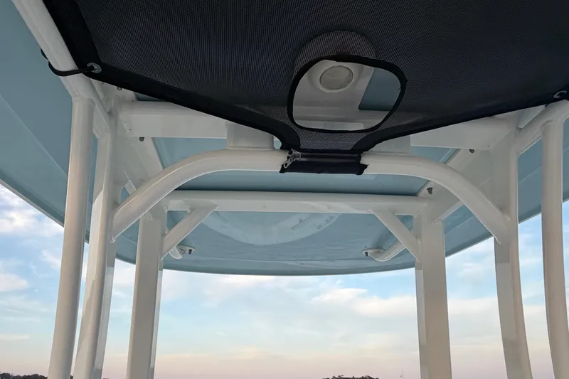 Slide: The Image of T-top structure of 2023 Boston Whaler 220 Dauntless against a clear sky. - 48