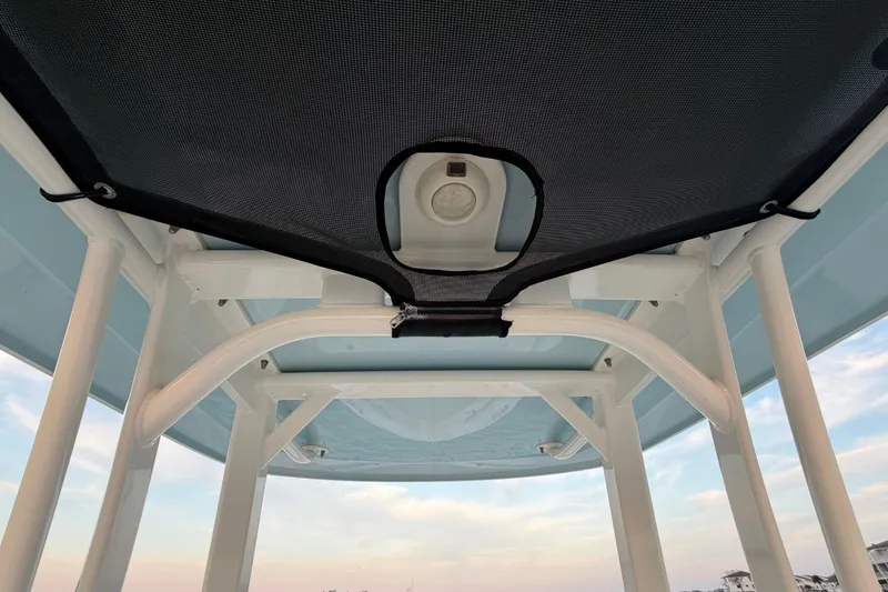 Slide: The Image of 2023 Boston Whaler 220 Dauntless T-top interior view with sky background. - 50