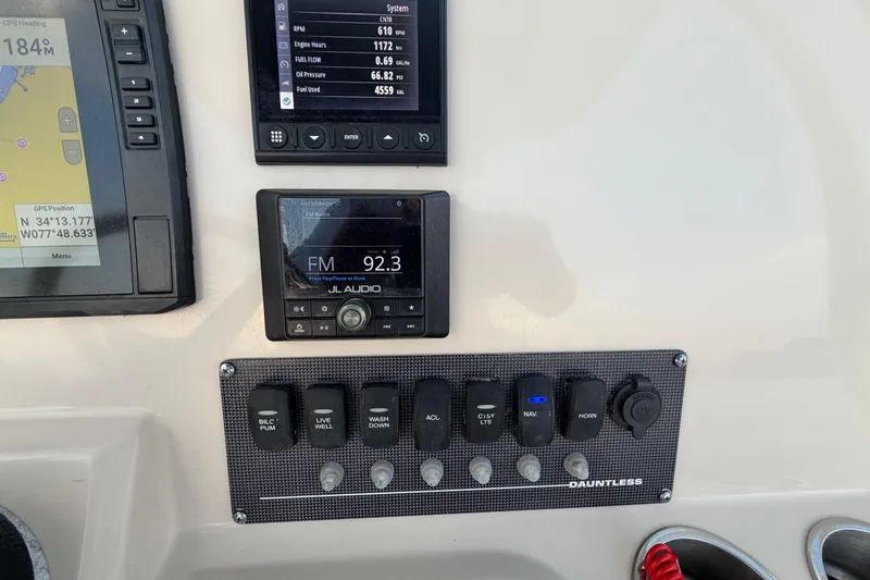 Slide: The Image of Control panel of 2023 Boston Whaler 220 Dauntless with GPS, audio, and system displays. - 52