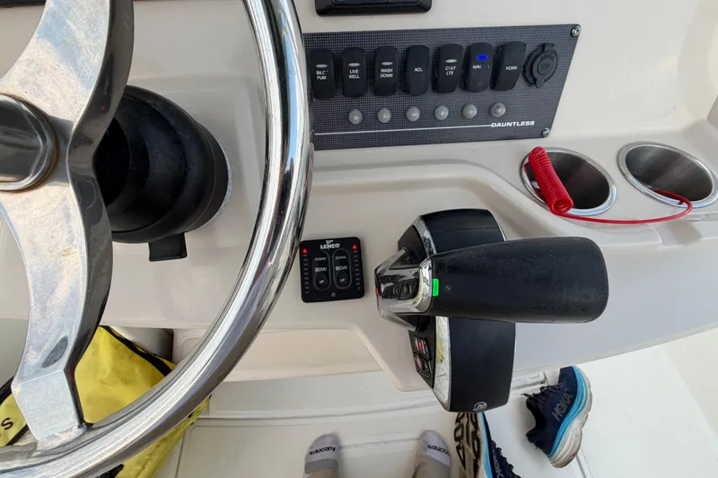 Slide: The Image of Control panel of 2023 Boston Whaler 220 Dauntless boat with steering wheel and throttle. - 53